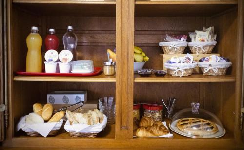 a wooden shelf with bread and other items on it at BeB Terrazza del Sole in Pisa
