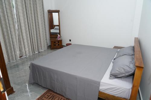 a bedroom with a bed in a room at The Alvis Nest in Kadawatha
