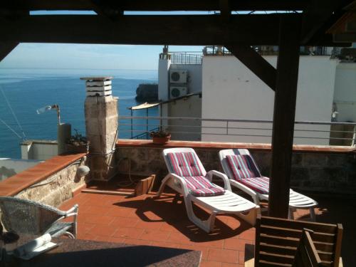 two chairs on a balcony with a view of the ocean at B&B Casa Dorsi in Polignano a Mare