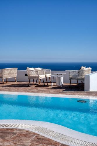 a pool with chairs and a table and the ocean at Casa Serena 10 Boutique- Adults Only-Breakfast Included in Mácher