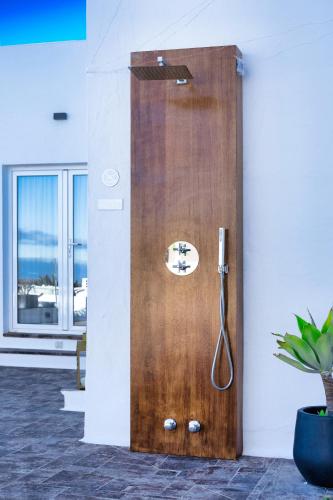 a wooden shower door in a room with a plant at Casa Serena 10 Boutique- Adults Only-Breakfast Included in Mácher