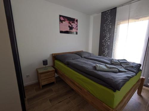a bedroom with a bed with a mirror on it at "Natur-Retreat am Bodden mit Kranichbeobachtung"-Haus kleiner Kranich in Neuendorf Hof