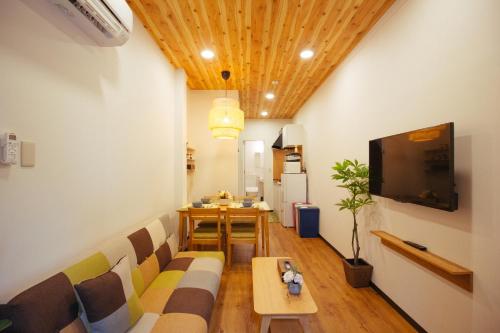 a living room with a couch and a table at JS暁宅-芦原橋 ashiharabashi in Osaka