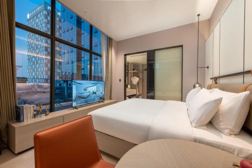 Postel nebo postele na pokoji v ubytování ONESS Executive Hotel Guangzhou Huangpu Luogang