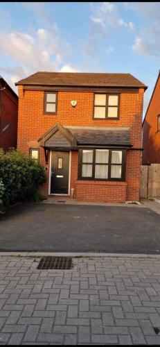 a brick house with a driveway in front of it at En-suite House, Minimum 3 nights bookings in Stockport