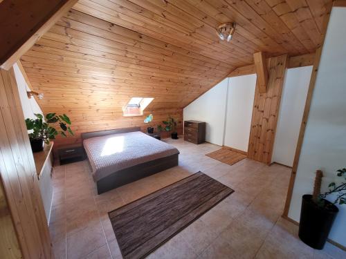 a bedroom with a bed and a wooden ceiling at Atrium Jerzmanowice in Jerzmanowice