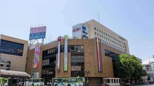 a building with buses parked in front of it at Hotel Metropolitan Morioka in Morioka