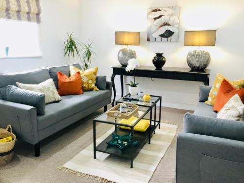 a living room with two couches and a coffee table at Bell Cottage by Ludlow Castle with onsite parking in Ludlow