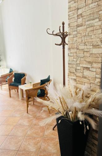 a living room with a vase with feathers in it at Art HOTEL in Chomutov