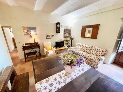 a living room with a couch and a table at Exclusive pool - wondrous views - biological Gardens - pool house - 12 guests in Marzolini