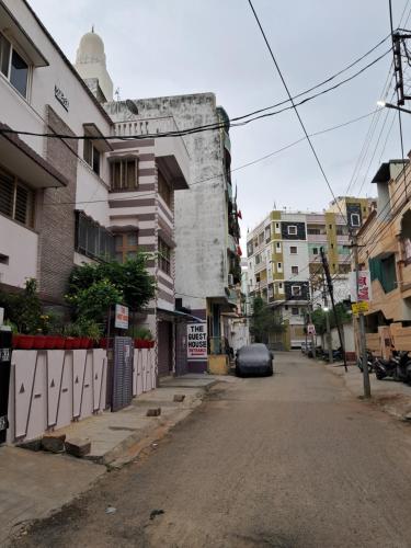 an empty street in a city with buildings at 1 Room for 4 Guests OR 2 BHK for 4 to 10 Guests with AC for Families in Hyderabad