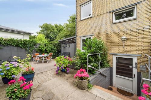 a patio with flowers and plants in front of a building at Copenhagen, Perfect apt. near the beach. in Copenhagen