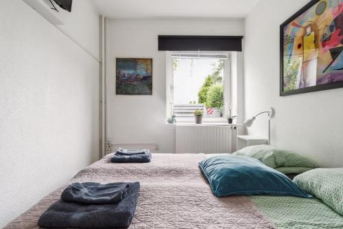 a bedroom with two beds and a window at Copenhagen, Perfect apt. near the beach. in Copenhagen