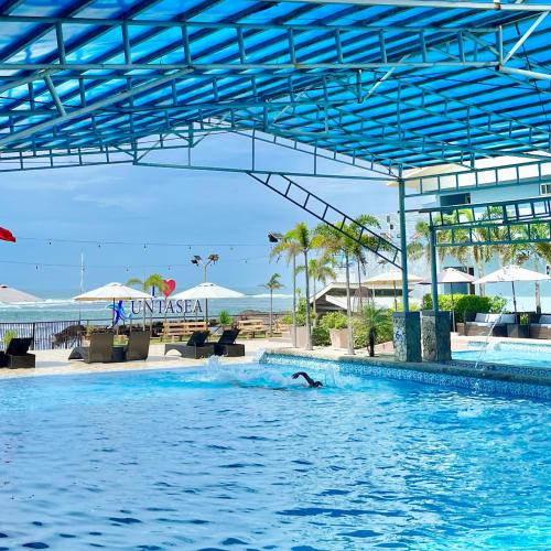 a person in the water in a swimming pool at Funtasea Hotel and Beach Resort in Iba