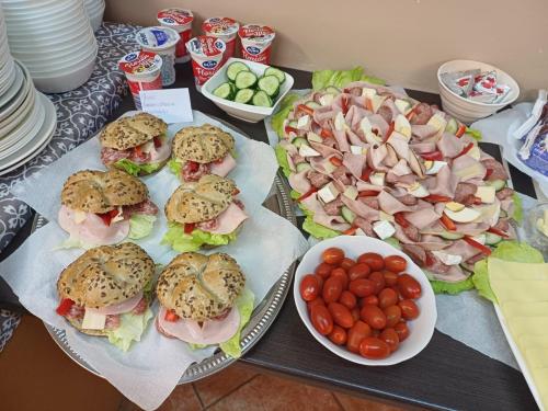 a table topped with sandwiches and a plate of food at Art HOTEL in Chomutov