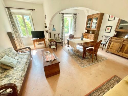 a living room with a couch and a table at Exclusive pool - wondrous views - biological Gardens - pool house - 12 guests in Marzolini