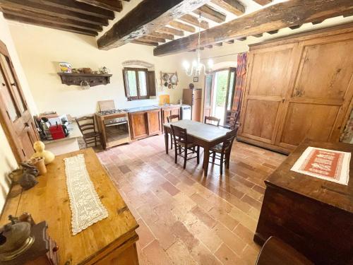 a kitchen and dining room with a table and chairs at Exclusive pool - wondrous views - biological Gardens - pool house - 12 guests in Marzolini