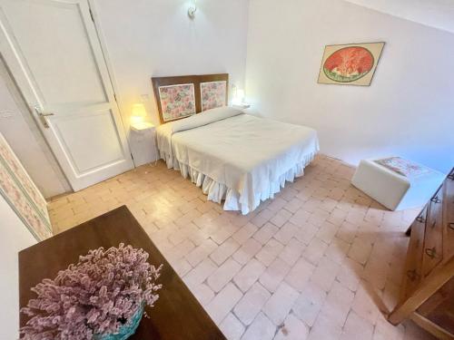 a bedroom with a bed and a table in a room at Exclusive pool - wondrous views - biological Gardens - pool house - 12 guests in Marzolini