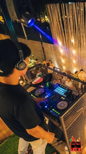 a man is standing in front of a mixing table at Ubox samui hostel & Bungalow - Chaweng beach in Chaweng