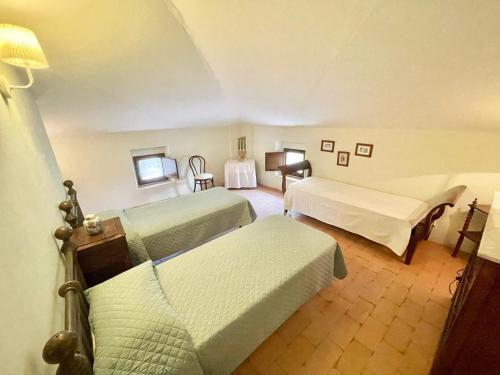 a hotel room with two beds and a table at Exclusive pool - wondrous views - biological Gardens - pool house - 12 guests in Marzolini