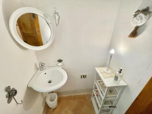 a bathroom with a sink and a mirror at Exclusive pool - wondrous views - biological Gardens - pool house - 12 guests in Marzolini