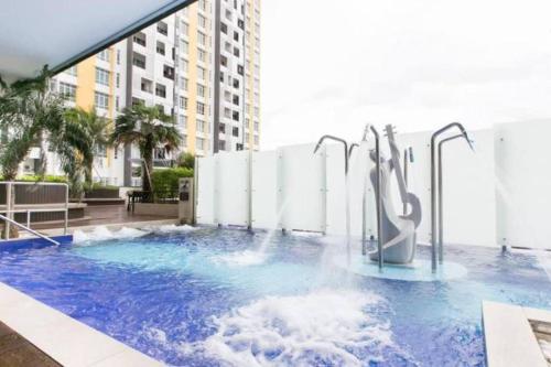 a pool with a water slide in a building at The Majestic Condo Ipoh Home Fairy 3 in Ipoh