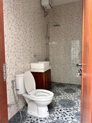 a bathroom with a toilet and a sink at Jimbaran in Jimbaran