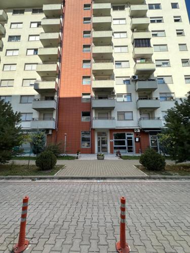 a parking lot in front of a large building at X apartment - Charming 1BR Retreat apartment in Pristina