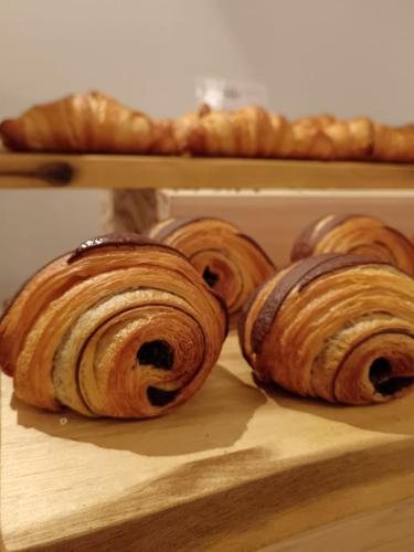 three croissants are sitting on a cutting board at Wine Hotel Ristorante San Carlo - Boutique Hotel & SPA in Chiuro