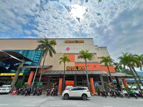 a hotel with motorcycles parked in front of a building at Sky Hotel Selayang in Batu Caves