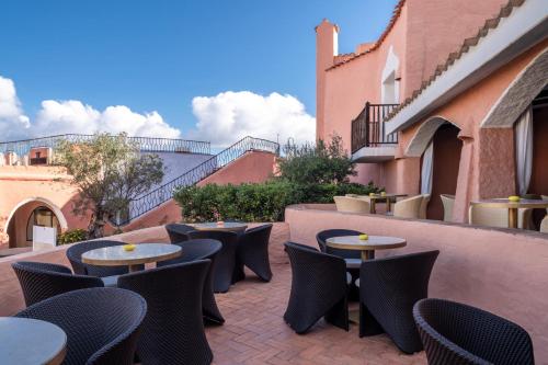an outdoor patio with tables and chairs and stairs at Cervo Hotel,Costa Smeralda Resort in Porto Cervo