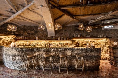 a bar with a stone counter and bar stools at Cervo Hotel,Costa Smeralda Resort in Porto Cervo
