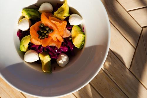 a white bowl filled with vegetables on a table at Cervo Hotel,Costa Smeralda Resort in Porto Cervo
