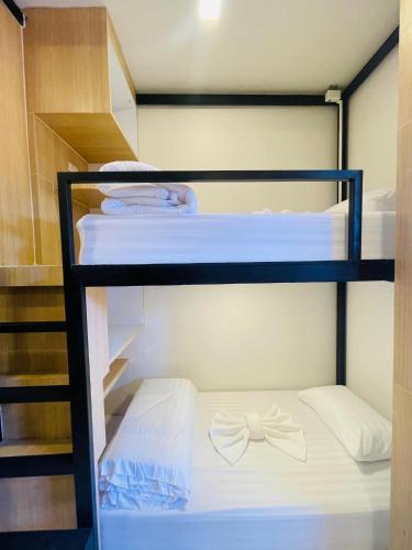a group of bunk beds with a bow tie on them at Lamoon Villa in Hat Yai