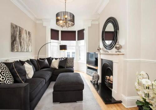 a living room with a black couch and a mirror at The Haven in York