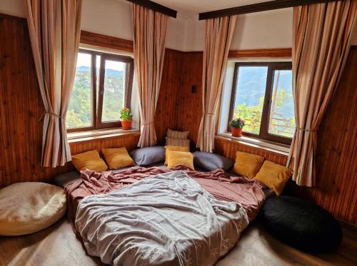 a large bed in a room with windows at Вила Леска in Leska