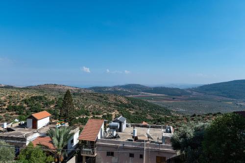 a view of a house with mountains in the background at וילה קצה ההרים- וילה מדהימה עם בריכה פרטית מול נוף מהמם in ‘Ein el Asad