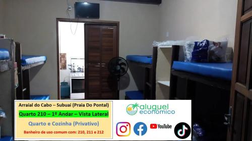 a room with blue beds and a sign in front of a door at Arraial do Cabo – Subuai Village - Aluguel Econômico in Arraial do Cabo