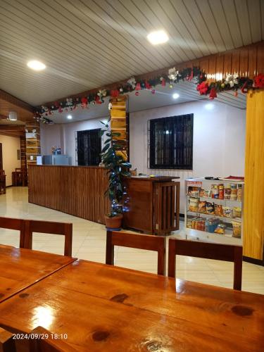 a restaurant with wooden tables and christmas decorations at FRIX HOMESTAY and RESTAURANT in Banaue