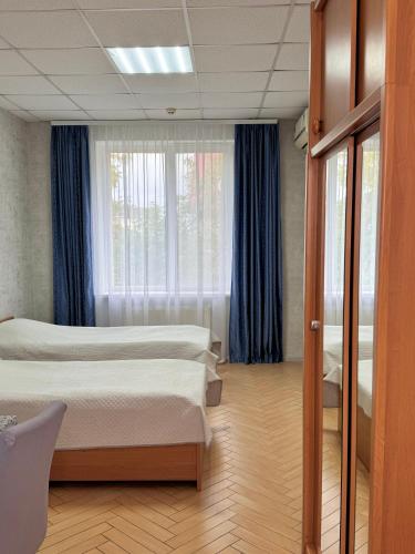 a bedroom with two beds and a window at Hotel Vesta in Brovary