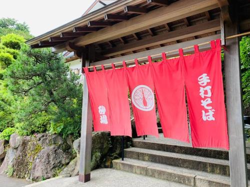 a group of red banners hanging from a gazebo at 伊豆高原-忘我庵 Cozy Ocean View Villa in Ito