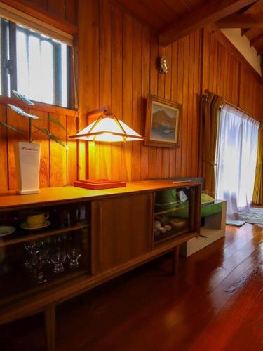 a kitchen with a counter with a light on it at 伊豆高原-忘我庵 Cozy Ocean View Villa in Ito