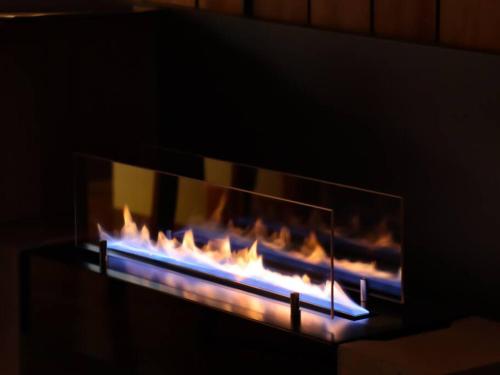 a fire in a fireplace with flames in it at 伊豆高原-忘我庵 Cozy Ocean View Villa in Ito