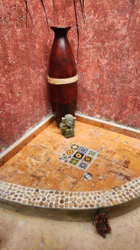 a large vase sitting on top of a wooden table at Casa Colonial Estate, Cozumel in Cozumel