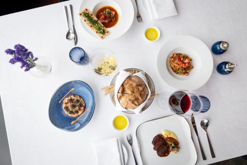 a white table with plates of food on it at The Ritz-Carlton, Hong Kong in Hong Kong