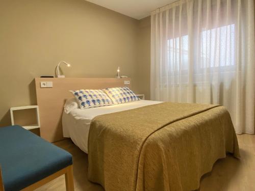 a bedroom with a large bed and a window at Hotel Baltico 2 estrellas in Luarca