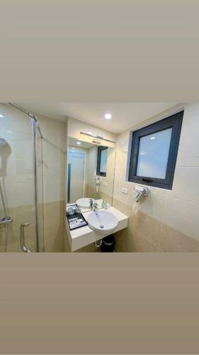 a bathroom with a sink and a shower at EVEREST HOTEL in Hanoi