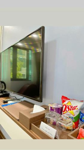 a desk with a mirror and some food on it at EVEREST HOTEL in Hanoi