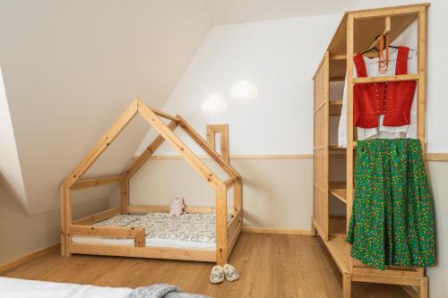 a room with a bunk bed and a shelf at Panocek i Babka in Białka Tatrzanska