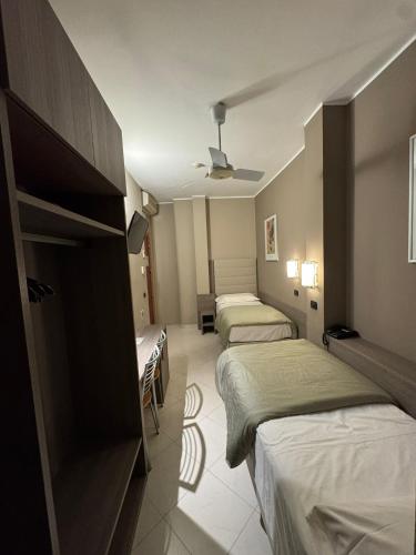 a room with three beds in a hotel room at Hotel Parma in Milan